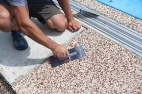 Professional concreter completing an exposed aggregate concrete project for a pool side commercial property in Frankston VIC.